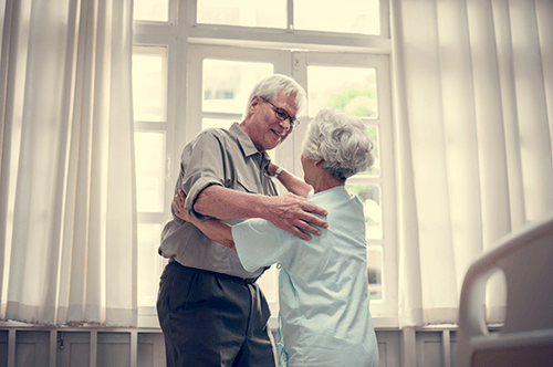 Patient hugging family member