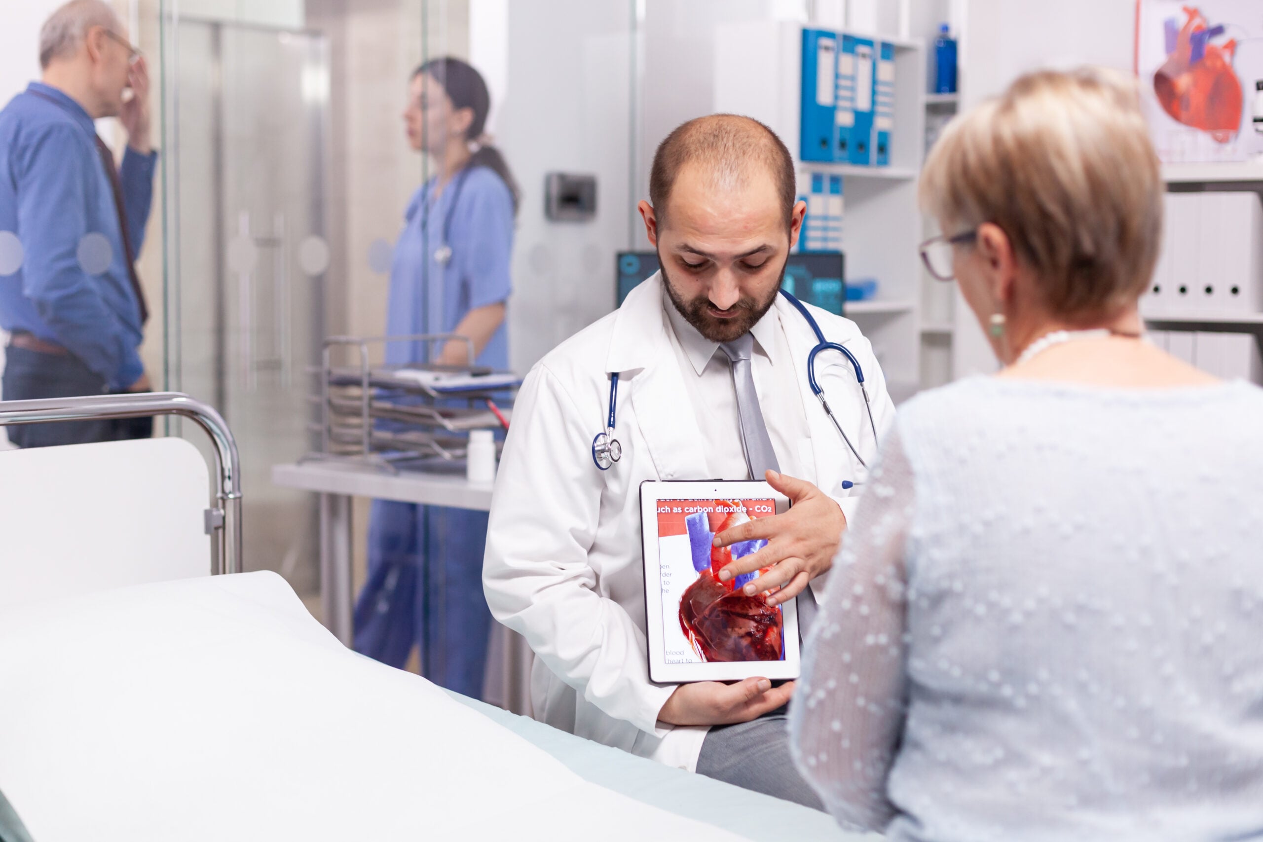 Doctor showing medical information abou the heart to a patient